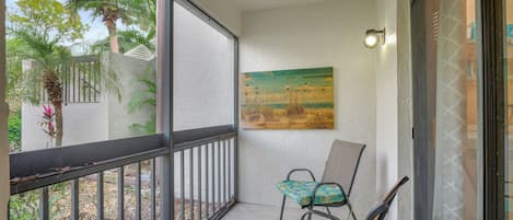 The Entrance to This First Floor Condo Has a Screened Lanai and Small Dining Set