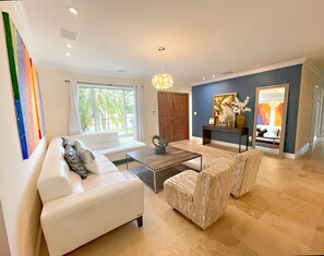 Cozy living room with original arts, overlooking the front garden.