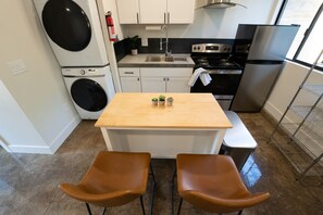 Full kitchen w/ stainless steel appliances and island 