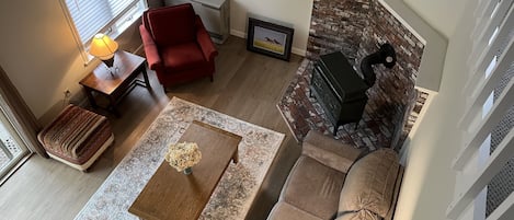 Light-filled cozy living room with wood-burning stove. Pic taken from upper loft