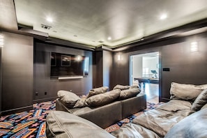 Custom theatre room with floor + ceiling LED lights and Sono's sound bar