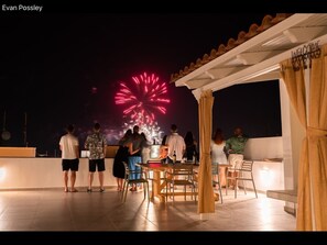 Guests enjoying a fire-works display from our roof terrace.