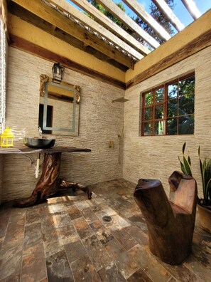 Enjoy nature with this semi-outdoor  shower in the master bedroom