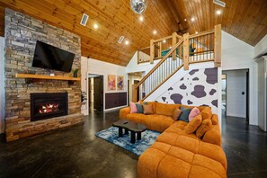 Cozy up by the stunning stone fireplace while watching your favorite shows on the Smart TV.