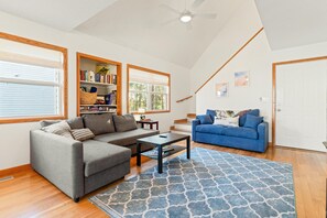 Vaulted living room with lots of light and full size sleeper sofa! 