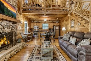 Great room boasts a 2 story stone fireplace withcraftsman log & wood throughout!