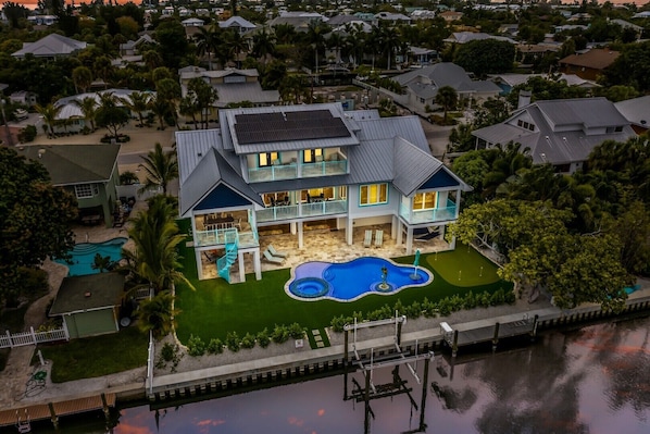 Snook Lookout - drone aerial view of backyard living area with pool and canal