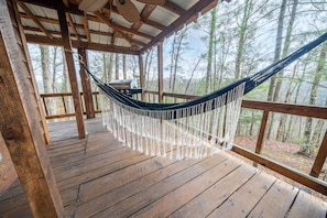 Relax on the back porch with seating and a hammock.
