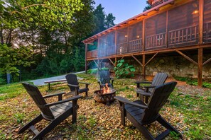 Fire pit with 5 Adirondack chairs and a bench