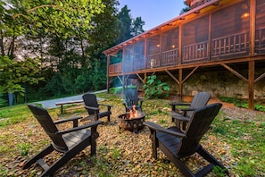 Fire pit with 5 Adirondack chairs and a bench