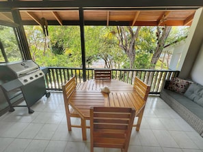 Dine al fresco with the sound of the ocean in the background on the screened balcony.  