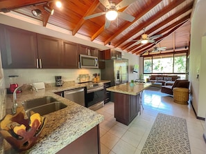 The kitchen has full-size, stainless steel appliances including a 5-burner stove and dishwasher.