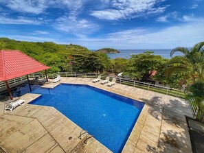 The large community pool offers beautiful ocean views, lounge chairs, and a shaded palapa area.  There are also washrooms and picnic tables available.  