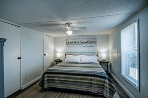 Bedroom with a king memory foam mattress, dresser, and closet.