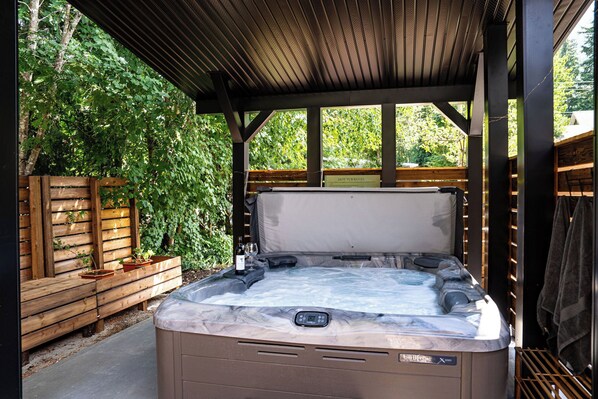 Covered, beautifully designed hot tub area