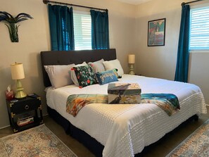 Get ready to relax! Welcome to our Peacock-themed King master bedroom. 