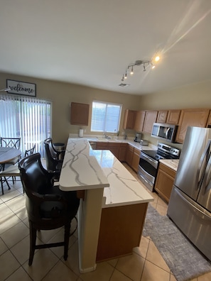 fully stocked kitchen with dishes, silverware, coffee maker and more!