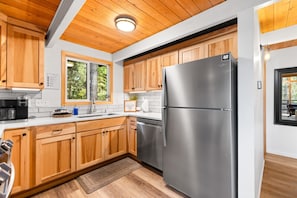 Refrigerator, dishwater, and barn sink in recently remodeled chef's kitchen
