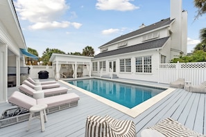Gorgeous pool deck. Jacuzzi is on the left and large dining table under gazebo!