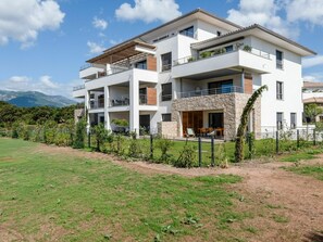 Sky, Plant, Cloud, Building, Window, Land Lot, Vegetation, Urban Design, Facade, Grass