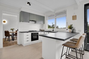 Cook, dine, and entertain in style in this sleek and spacious kitchen