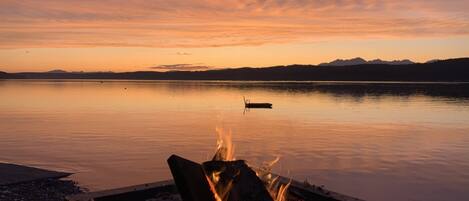 Wood fire pit tucked away at the waters edge