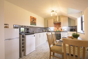 First floor: Dining table with seating for four guests