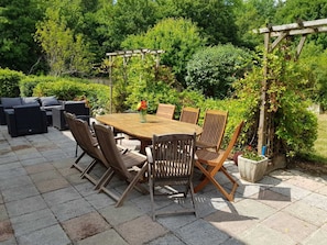 Large terrace with dining table and outdoor sofa