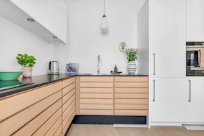 Kitchen - Please note that we have 3 apartments, they differ in design but have the same layout and are overall identical in quality level. We cannot guarantee that the apartment you'll get looks exactly as the photos. The apartments are located on the, 3rd, 4th and 5th floor.