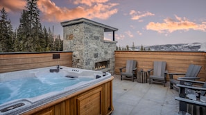 Private hot tub and outdoor gas fireplace on the roof level