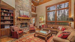 Main level great room with fireplace and deck access