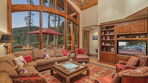 Main level great room with TV, views and deck access