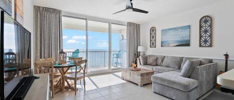 Living/dining area with a flat screen television and a view of the Gulf of Mexico.