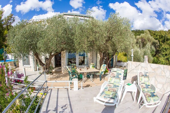  Wohnung - Eingang über große Terrasse mit Meerblick und 2 Olivenbäumen 