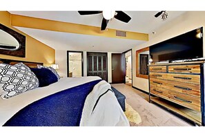 Master bedroom with king bed, ceiling fan, HD TV, en-suite bathroom