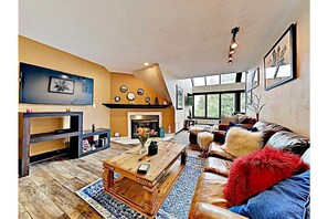 Decent sized living room with Smart HD TV, fireplace, mountain views