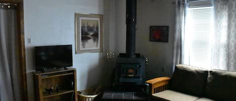 Cozy up in the improved Living Room around the warmth of the wood stove. 