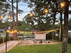 Backyard view with overhead lighting.