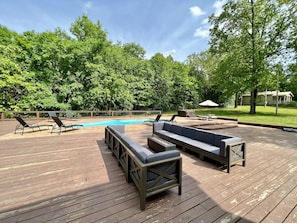 Large deck with plenty of seating, hot tub, picnic table, grill, basketball pad.