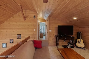 Loft area with 2 couches and TV