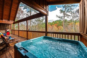 Relax in the hot tub on the wraparound deck with a peaceful view of nature
