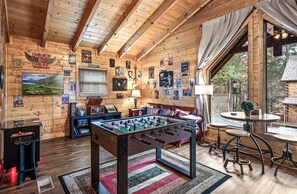 Music-themed loft with a foosball table, arcade game, TV, and music player