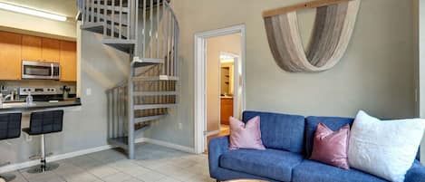 Living room with spiral stairs up to the loft bedroom