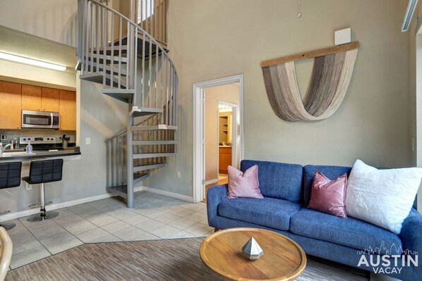 Living room with spiral stairs up to the loft bedroom