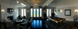 Living Room with custom 9' pool table and access to screened porches and patio.