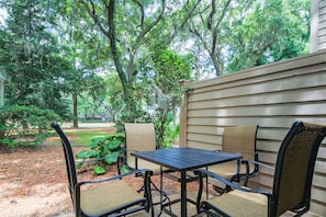 The high top dining table on the back patio has views of the golf course and beautiful Lowcountry trees.