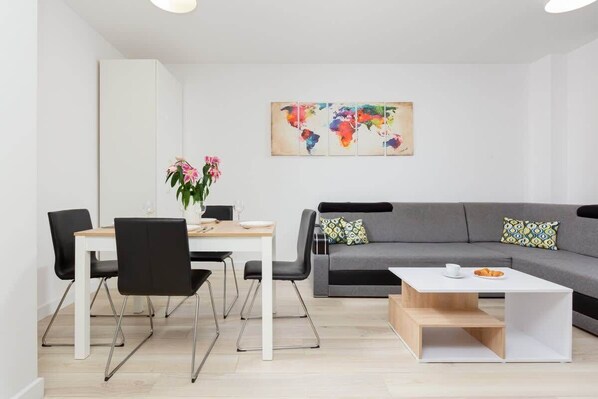A contemporary and inviting living room featuring gray sofa perfect for relaxing or entertaining guests in a bright and vibrant setting.