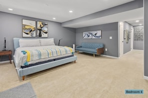Master suite delivers a king sized mattress, perfect for couples -basement-