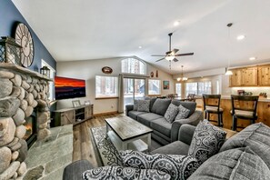 Welcome to the open-concept great room, complete with a TV, warm fireplace, and comfy seating for 5.