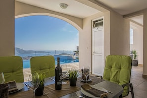 Dining area pictured in the shade of the pool level